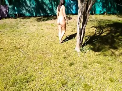Nude walking on a sunny day by the pool